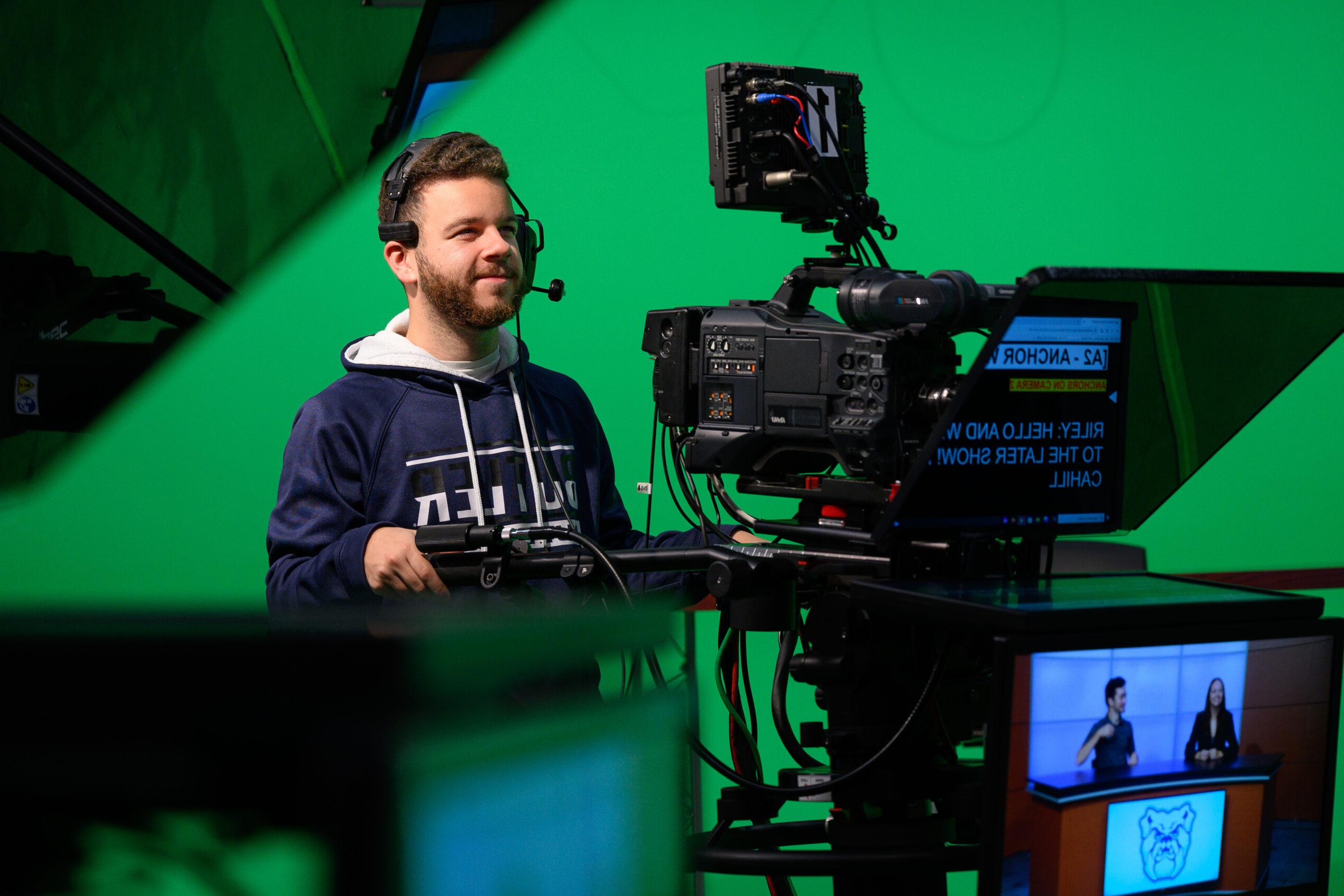 Male Butler student working a production camera during TV shoot.